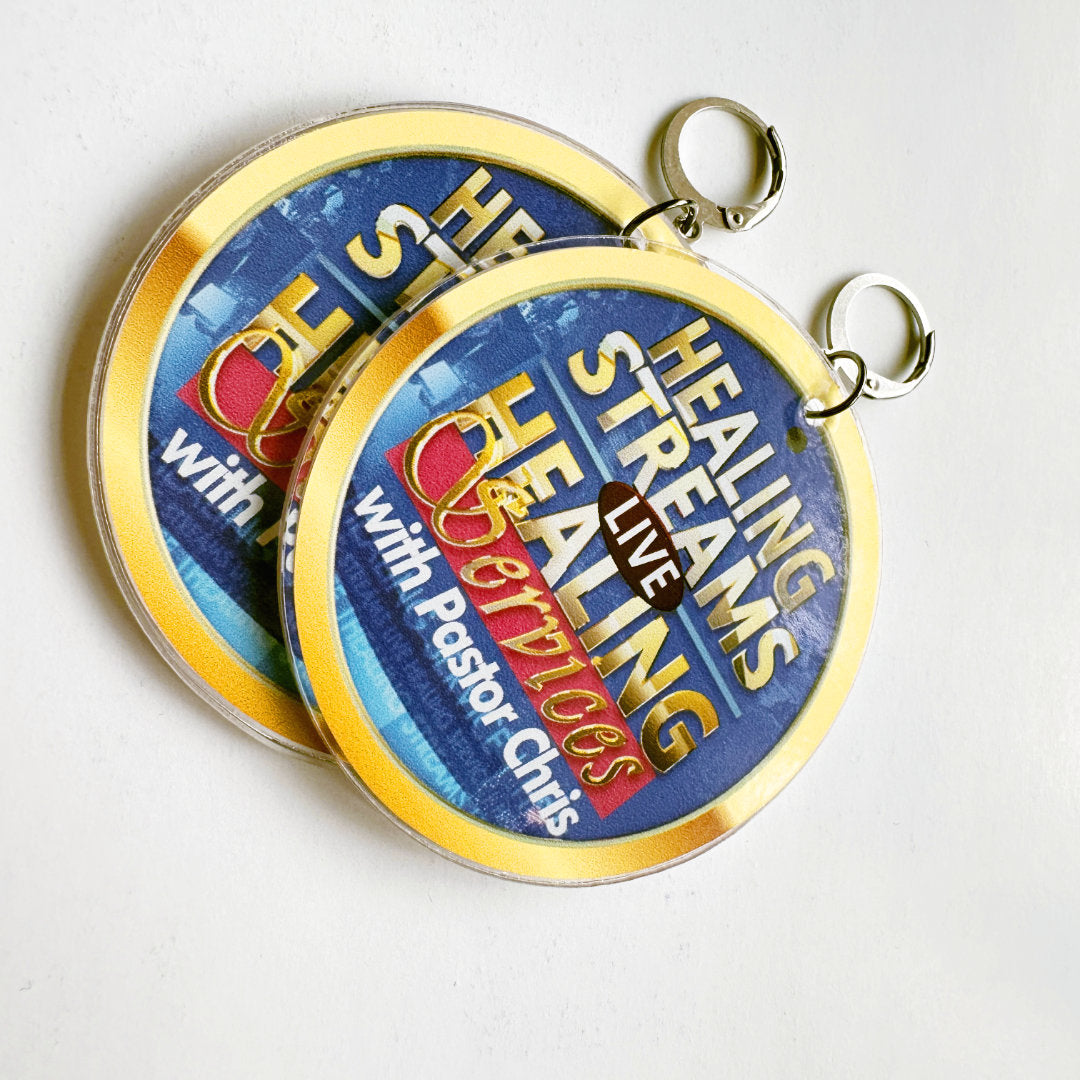 Earrings with 'Healing Streams with Pastor Chris' branding on a white background